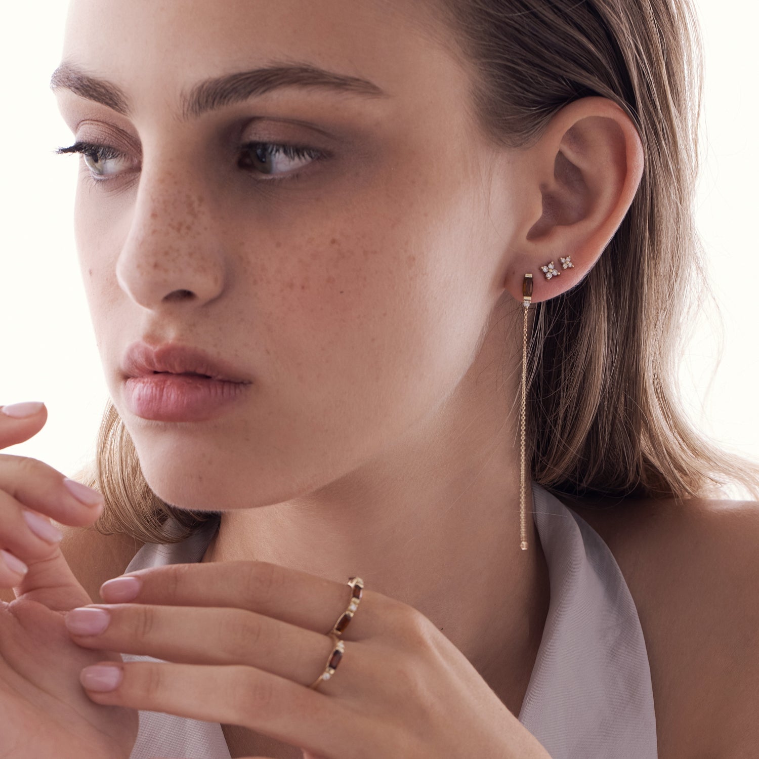 A special gold chain earring studded with gemstone, tourmaline and diamond