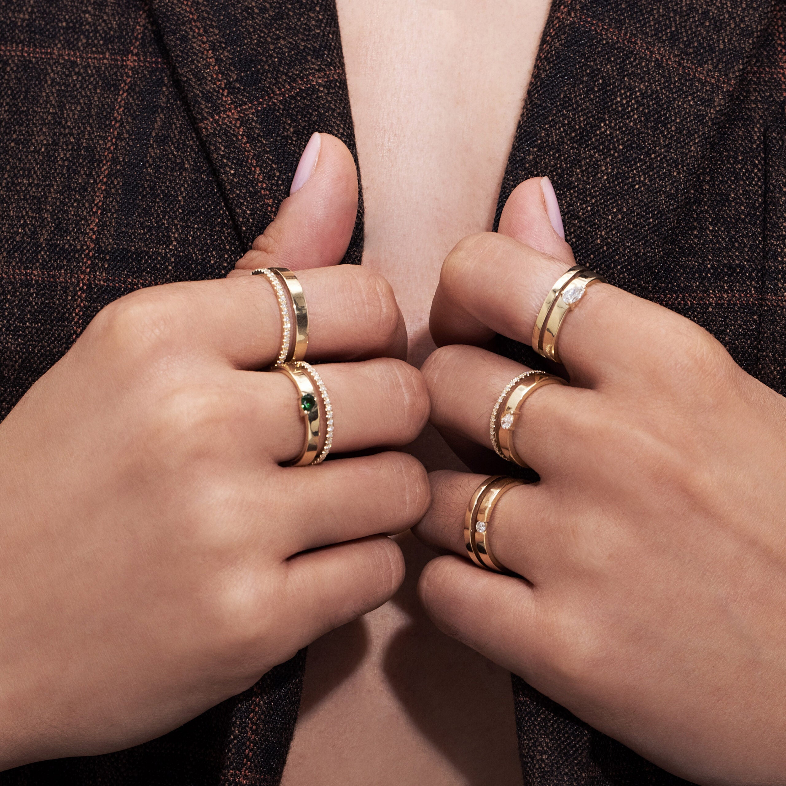 A double gold ring set with a row of diamonds and a drop-cut diamond weighing 10 points