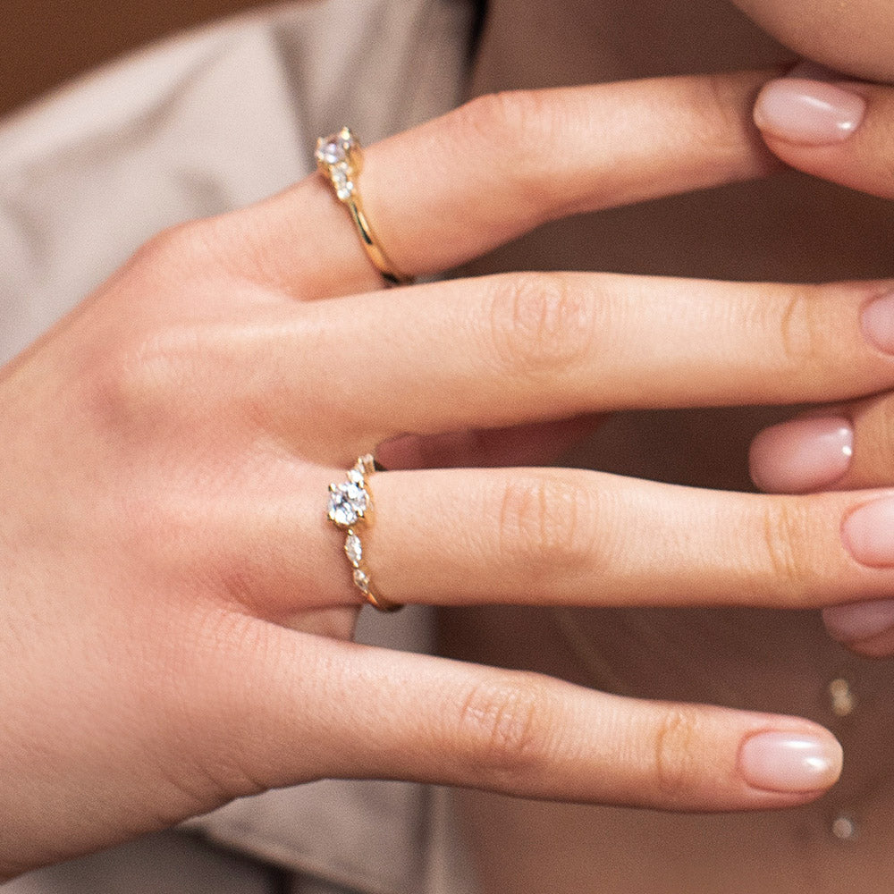 An engagement ring set with a central round lab diamond and 4 side lab diamonds