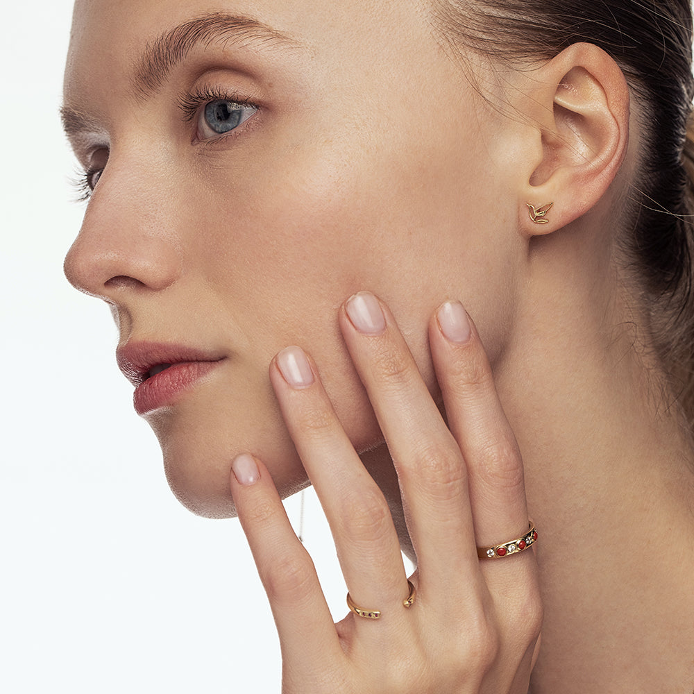 A special gold ring set with natural coral and laboratory diamonds