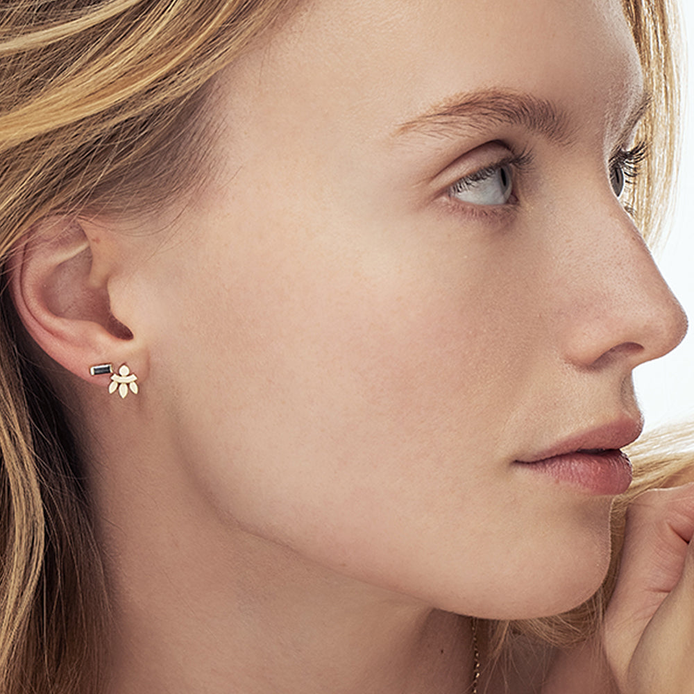 Tight gold earrings in an oriental design