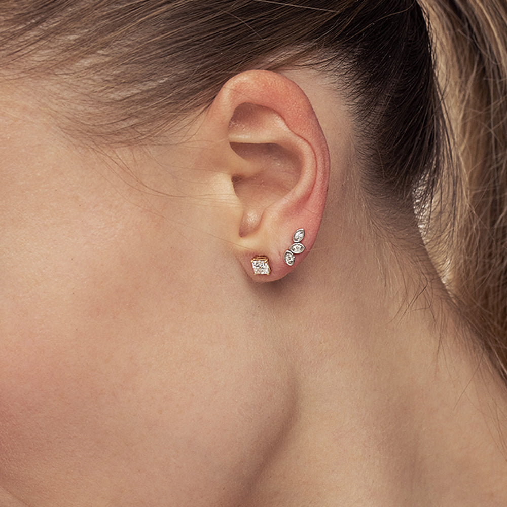 Climbing gold earrings in the shape of three leaves, set with diamonds