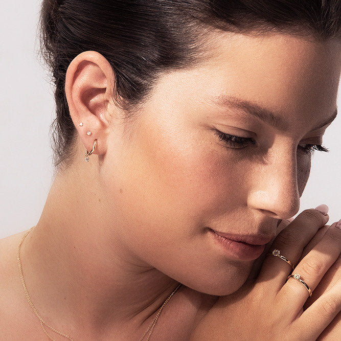 Gold hoop earrings with 20 point diamonds inlaid with teeth