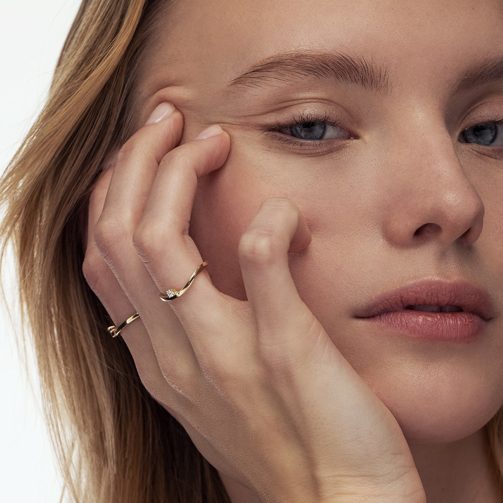 A fine and special gold ring set with a laboratory diamond weighing 5 points