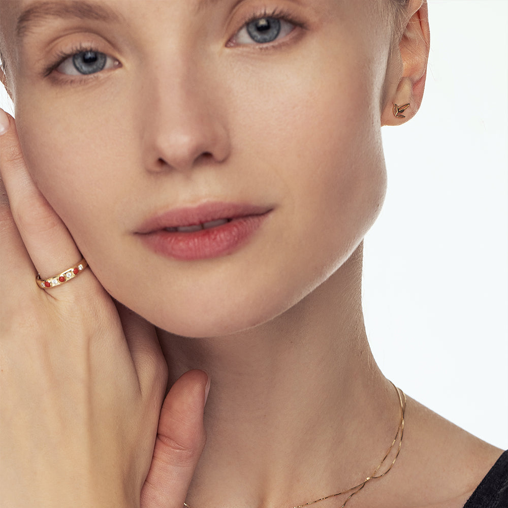 A special gold ring set with natural coral and laboratory diamonds