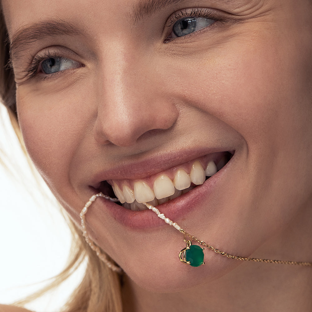 Gold necklace with mother of pearl and oval green onyx