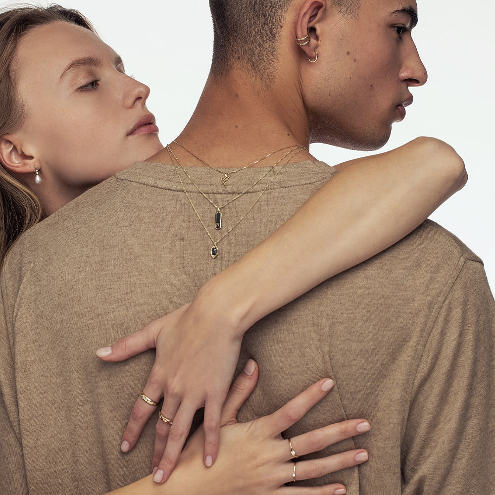 A gold chain with a modern evil eye pendant for men, inlaid with a marquise-cut sapphire
