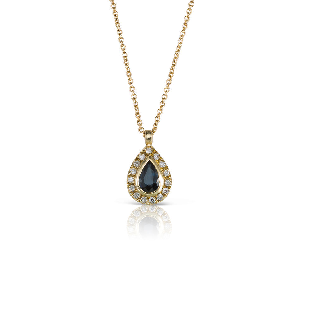 A classic gold chain, a drop-shaped sapphire studded pendant and diamonds all around