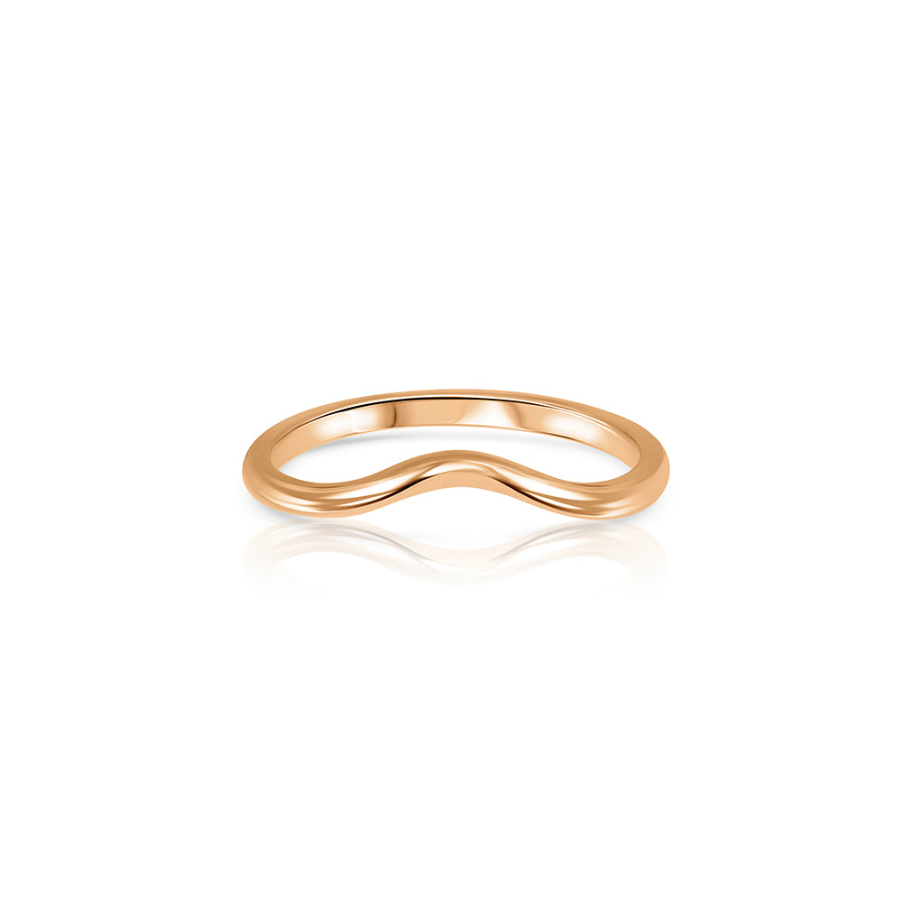 A gold wedding ring in the shape of a wave - a complementary ring