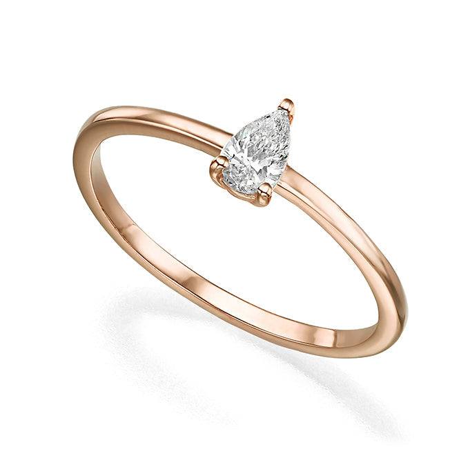 A delicate solitaire ring set with a drop-cut diamond