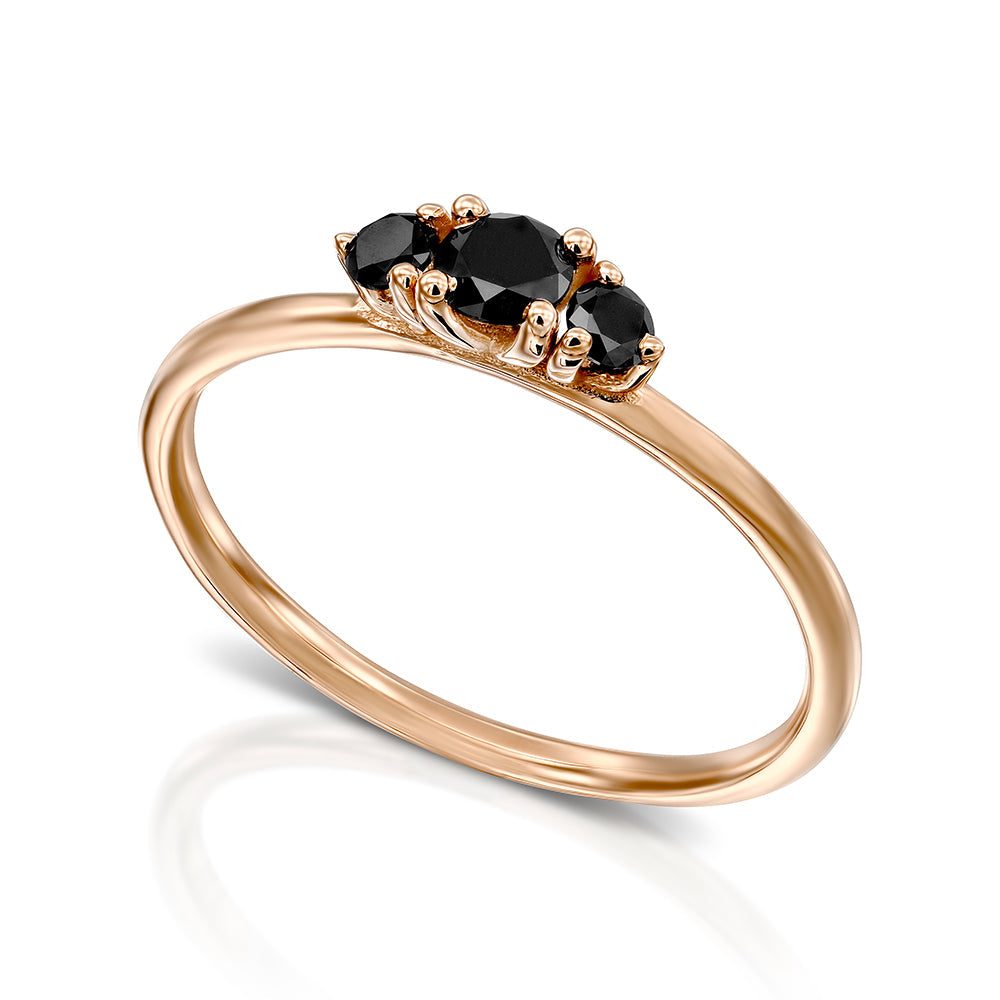 A fine gold ring set with three black diamonds