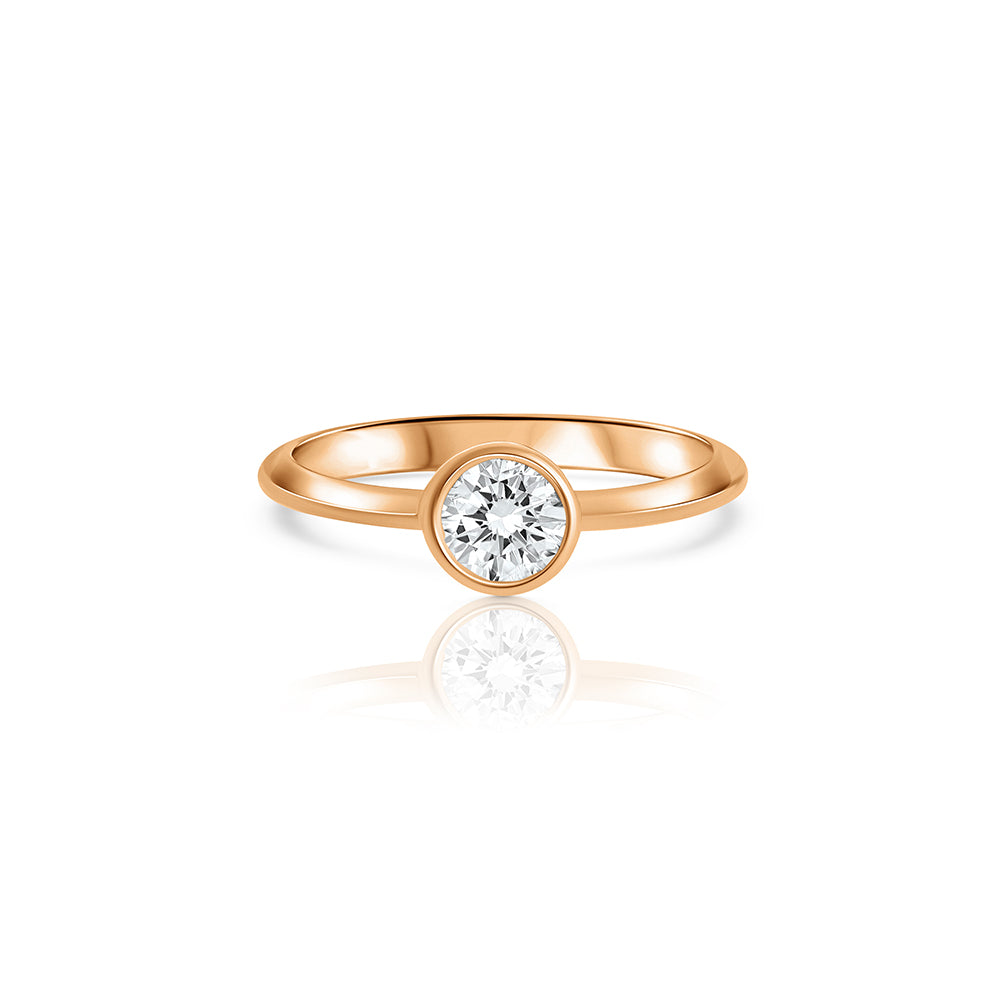A solitaire ring set with a half carat laboratory diamond in a gold frame.