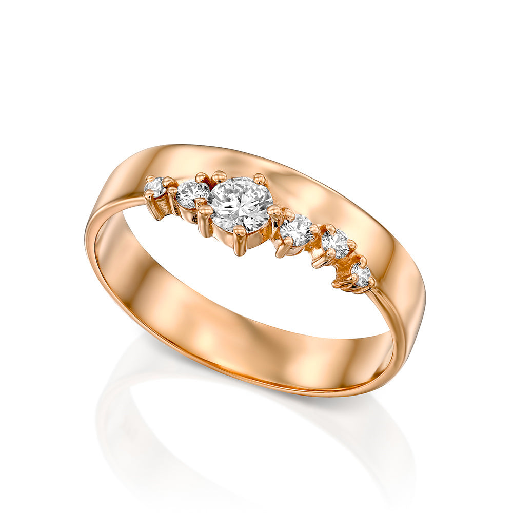 A wide gold ring with a special asymmetric setting of diamonds