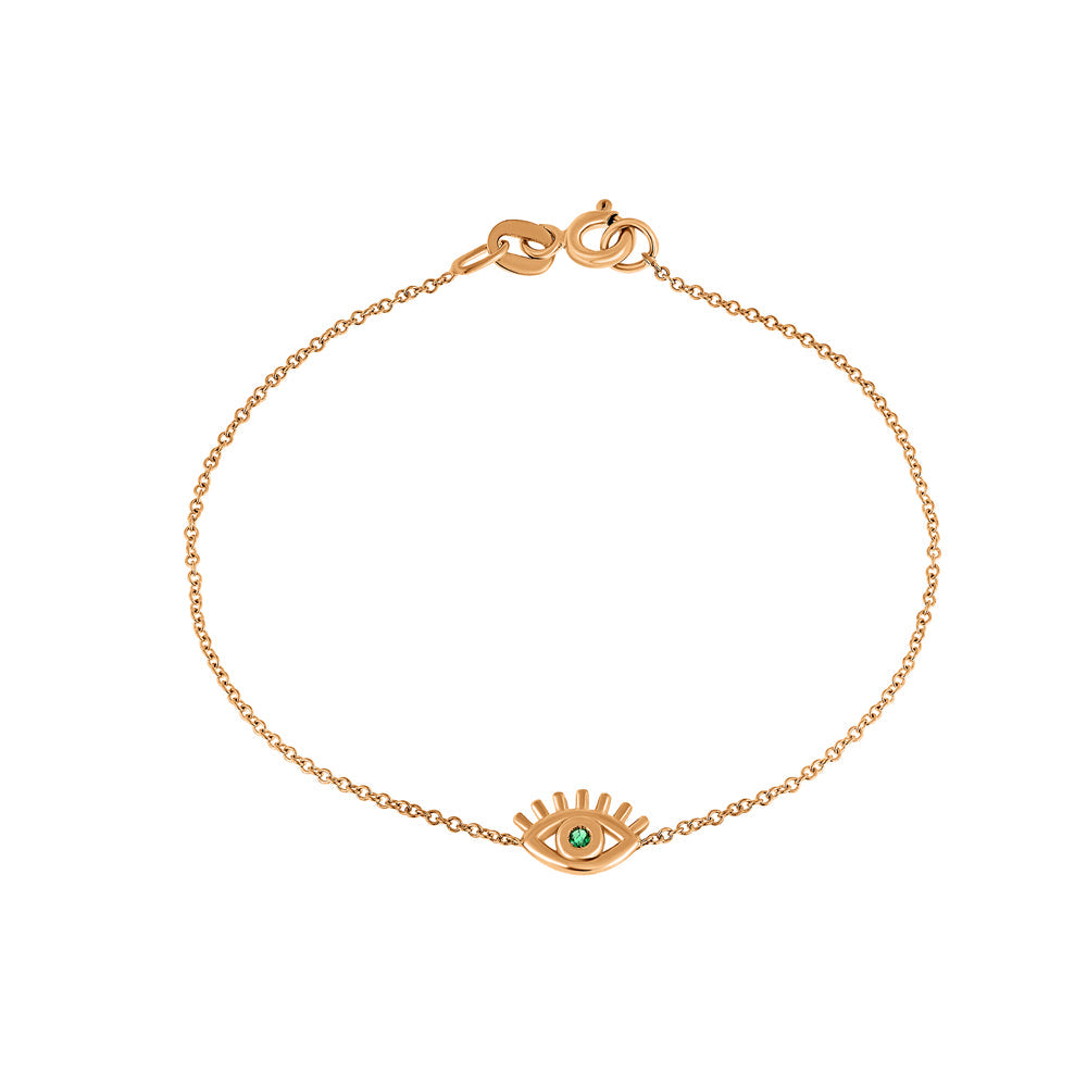 Modern fine gold eyelash bracelet with an emerald in the center