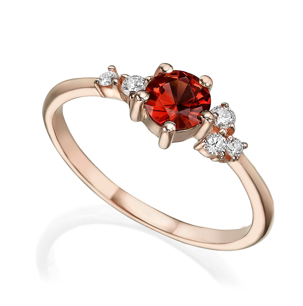 An engagement ring set with rhodolite and small one-centimeter diamonds