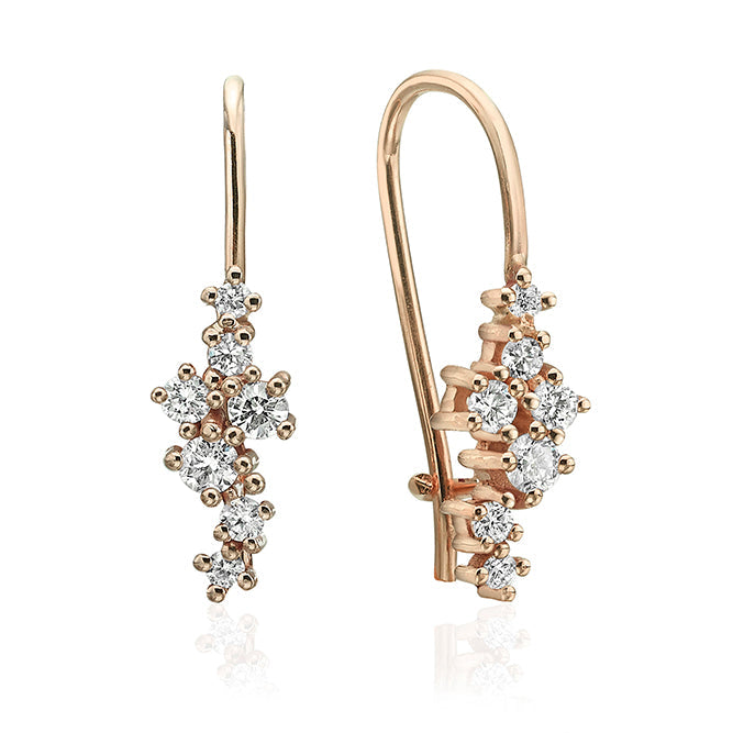 Hanging gold earrings studded with diamonds of varying sizes