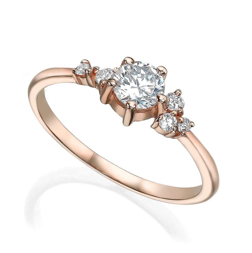 An engagement ring set with a half carat diamond and small asymmetric diamonds
