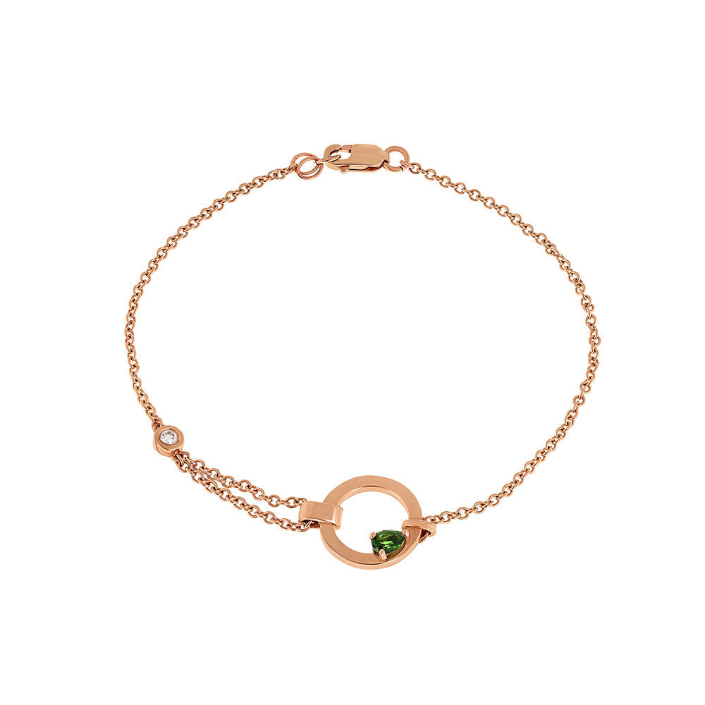 A special asymmetric gold bracelet, in a modern and impressive design. Inlaid green tourmaline and diamond.