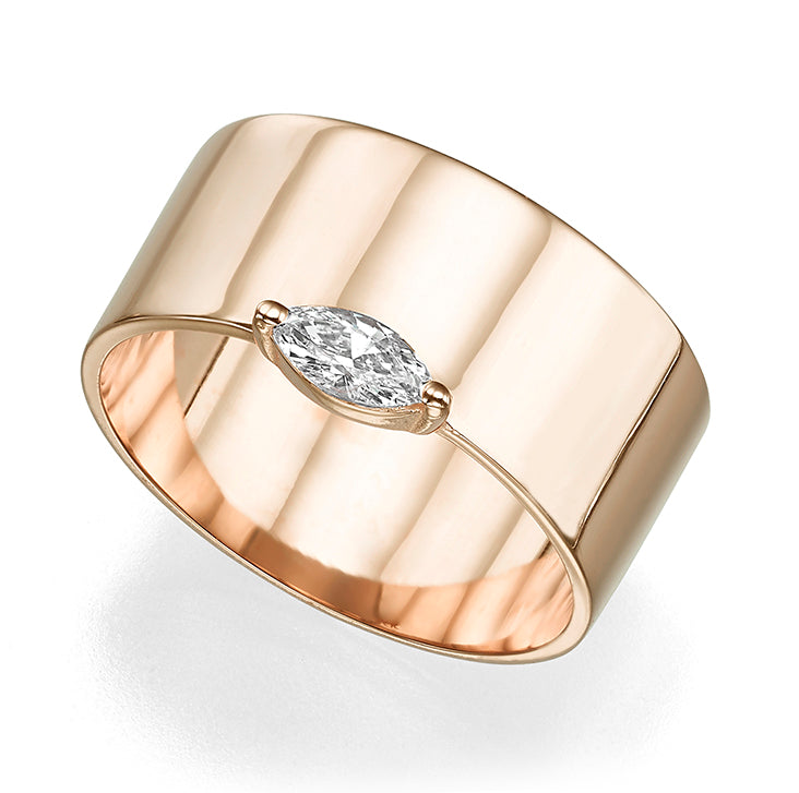 A wide gold ring set with a marquise-cut diamond