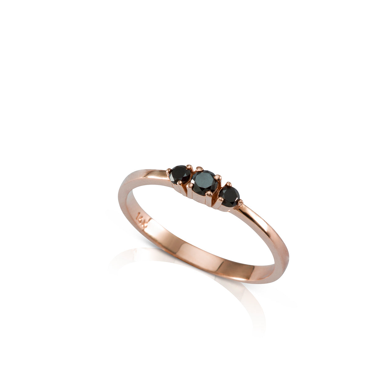 A gold ring set with three black diamonds