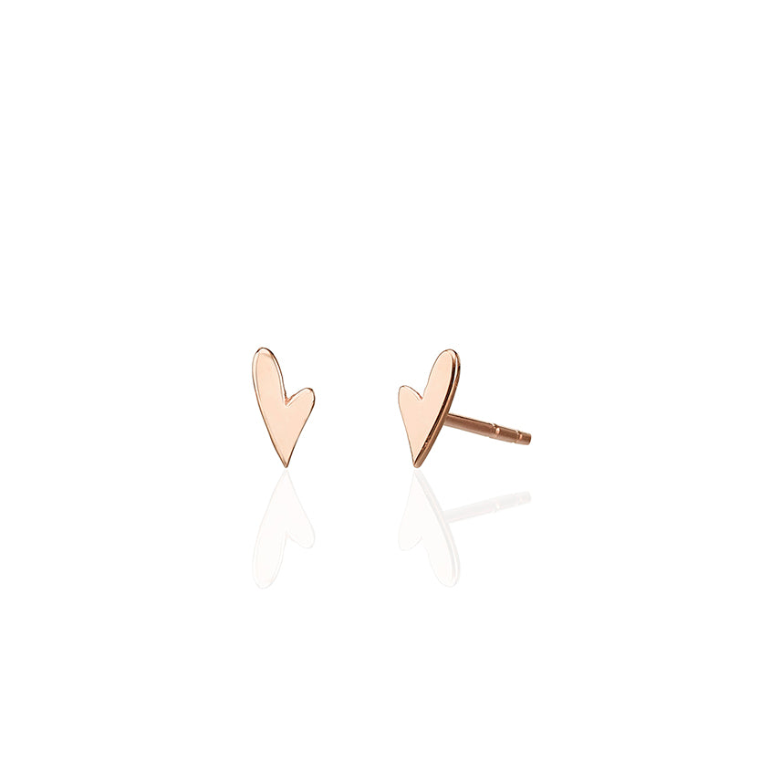 Small tight gold earrings in the shape of a small asymmetric heart