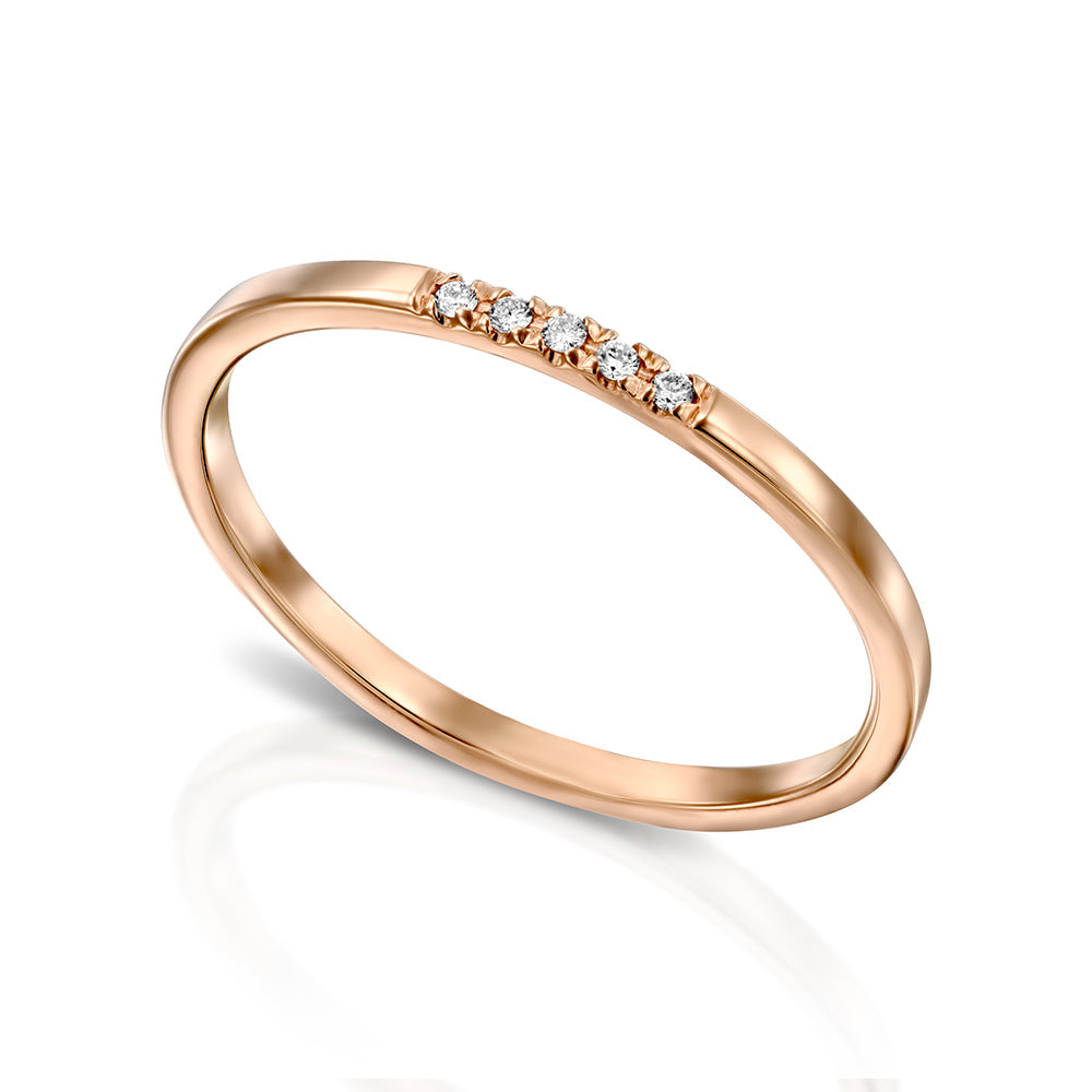 A thin gold ring with a square profile set with a row of five diamonds
