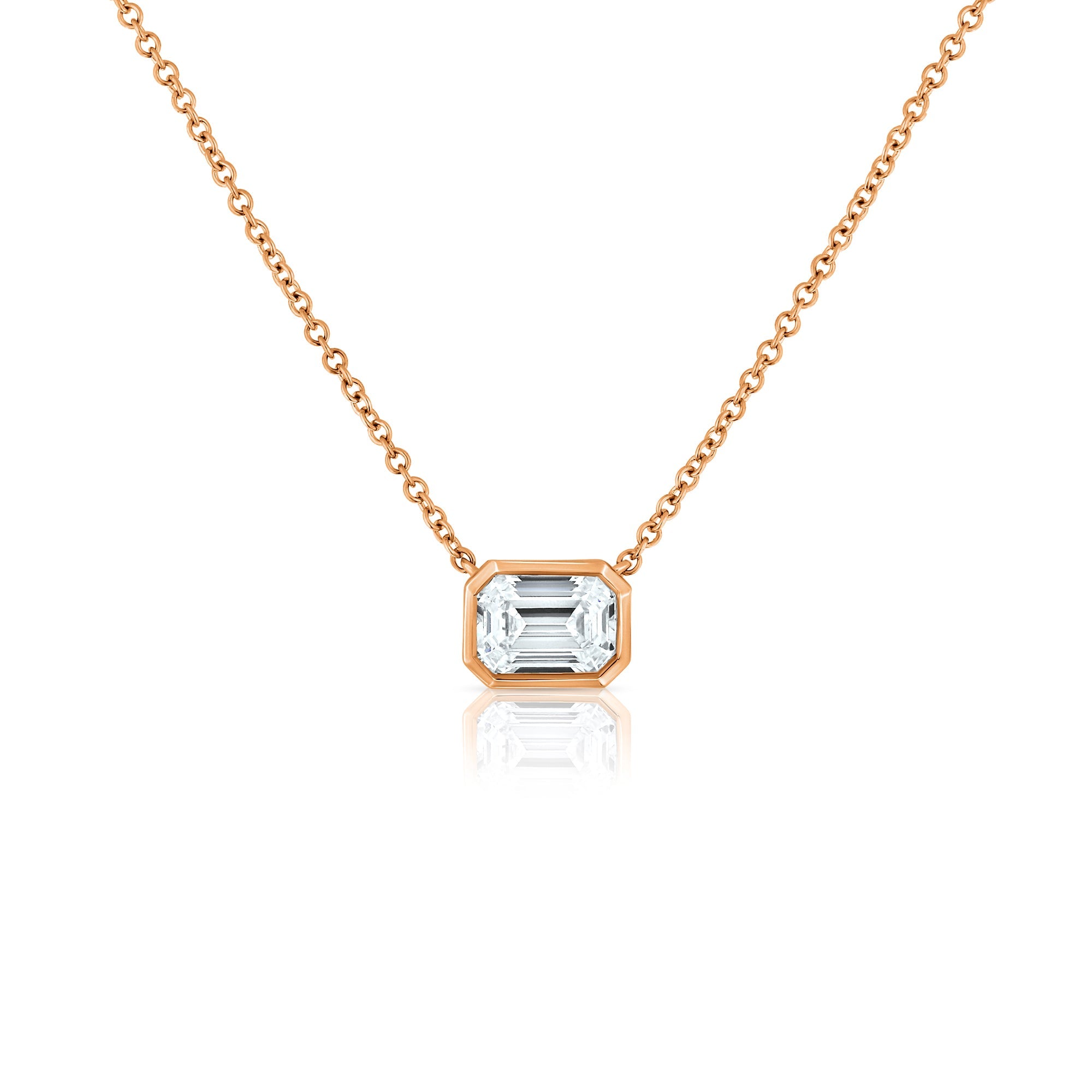 A classic gold necklace set with a 1 carat emerald cut lab diamond