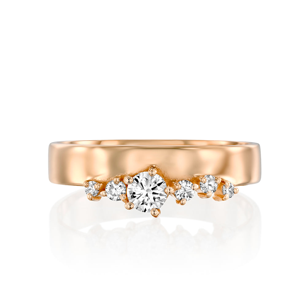 A wide gold ring with a special asymmetric setting of diamonds
