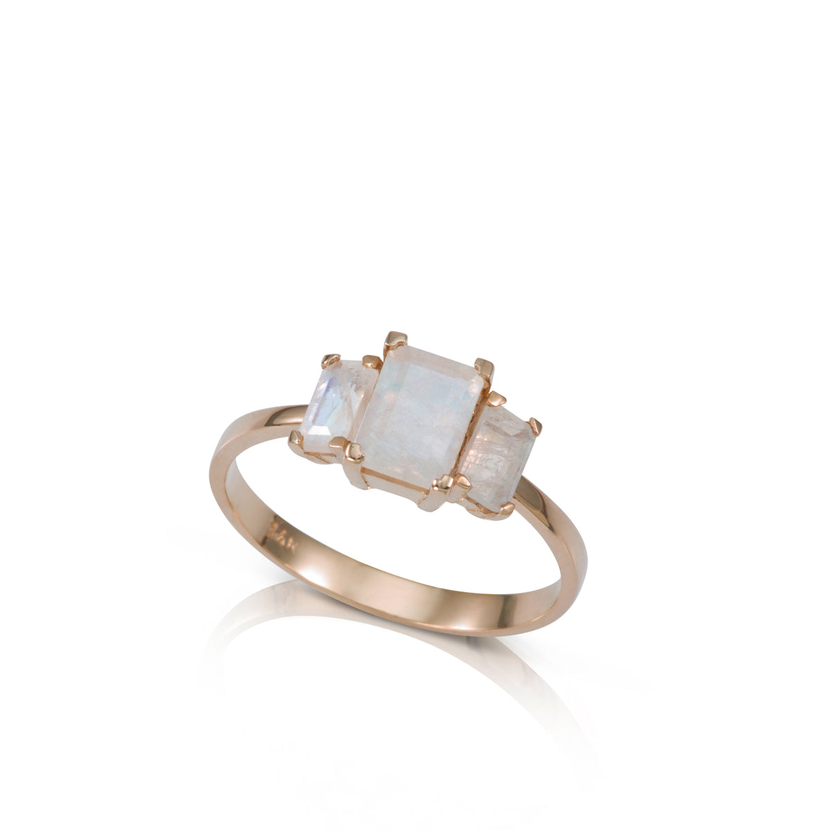 A gold ring inlaid with 3 moonstone stones in a rectangular cut