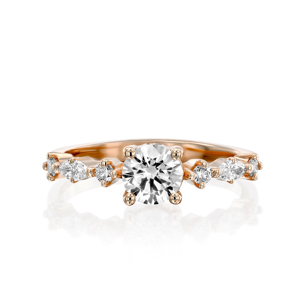 A diamond ring set with a 0.60 carat round diamond combined with marquise-cut diamonds