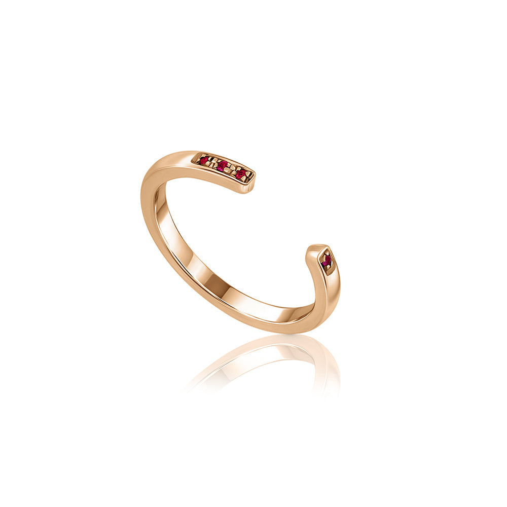 Open gold ring studded with rubies