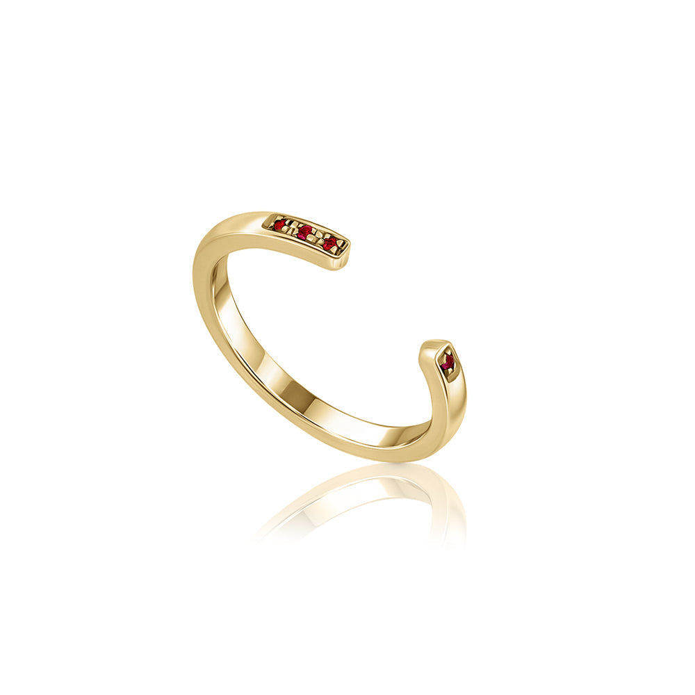 Open gold ring studded with rubies