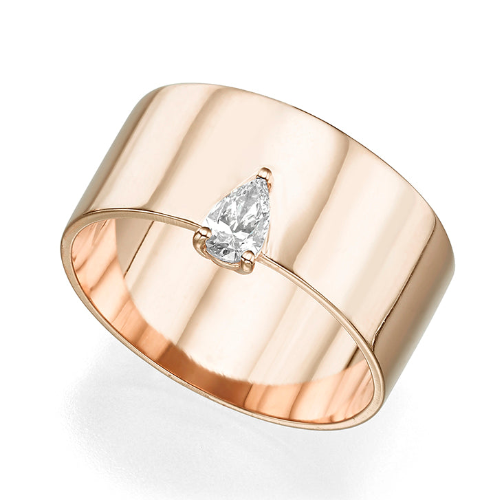 A wide gold ring set with a drop cut diamond