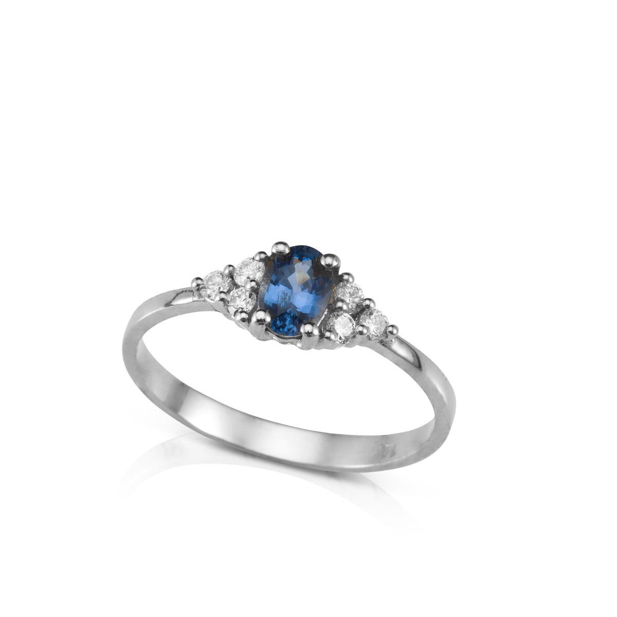 An engagement ring set with an oval-shaped sapphire and 6 sided diamonds