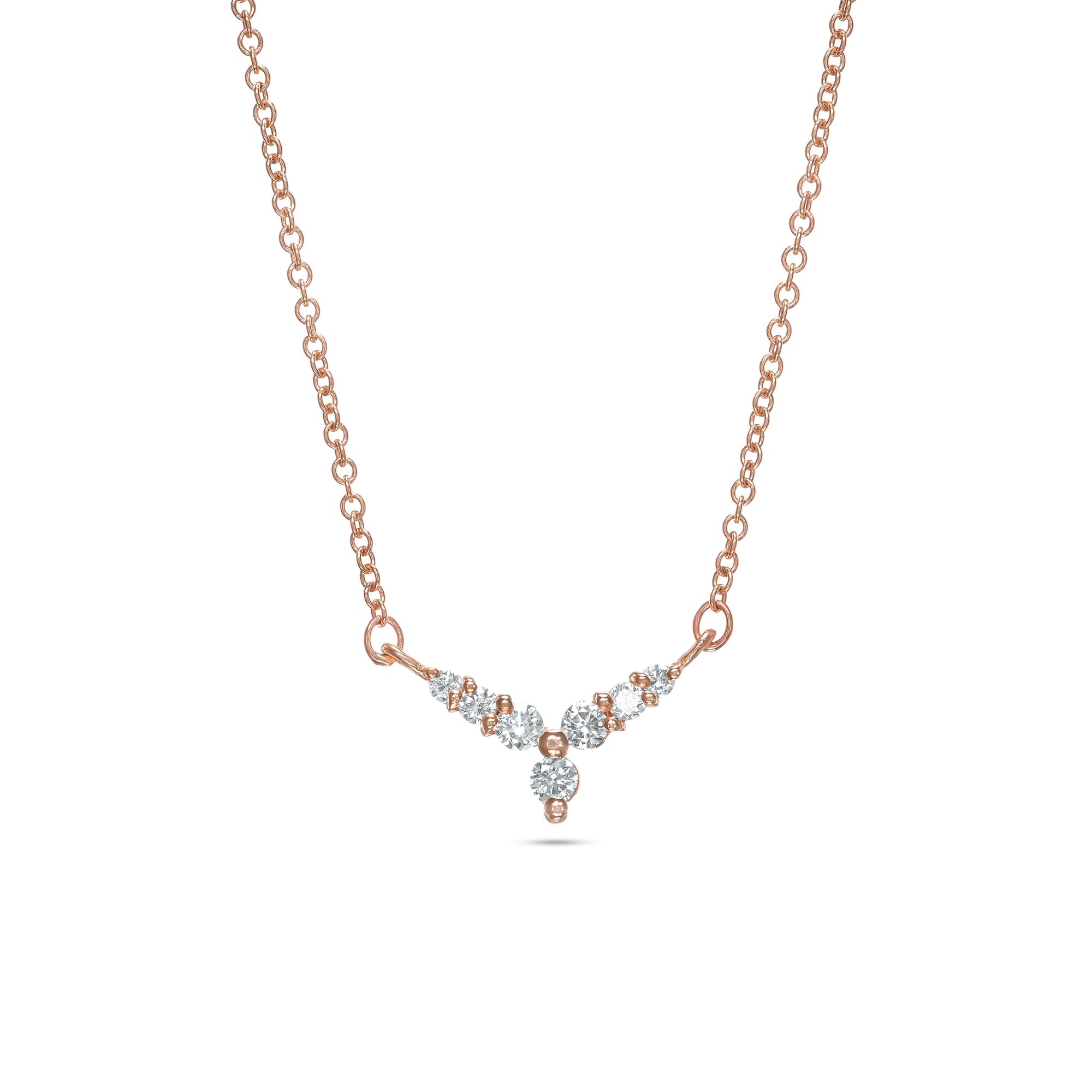 A gold necklace with a V-shaped pendant studded with diamonds reminiscent of a flower
