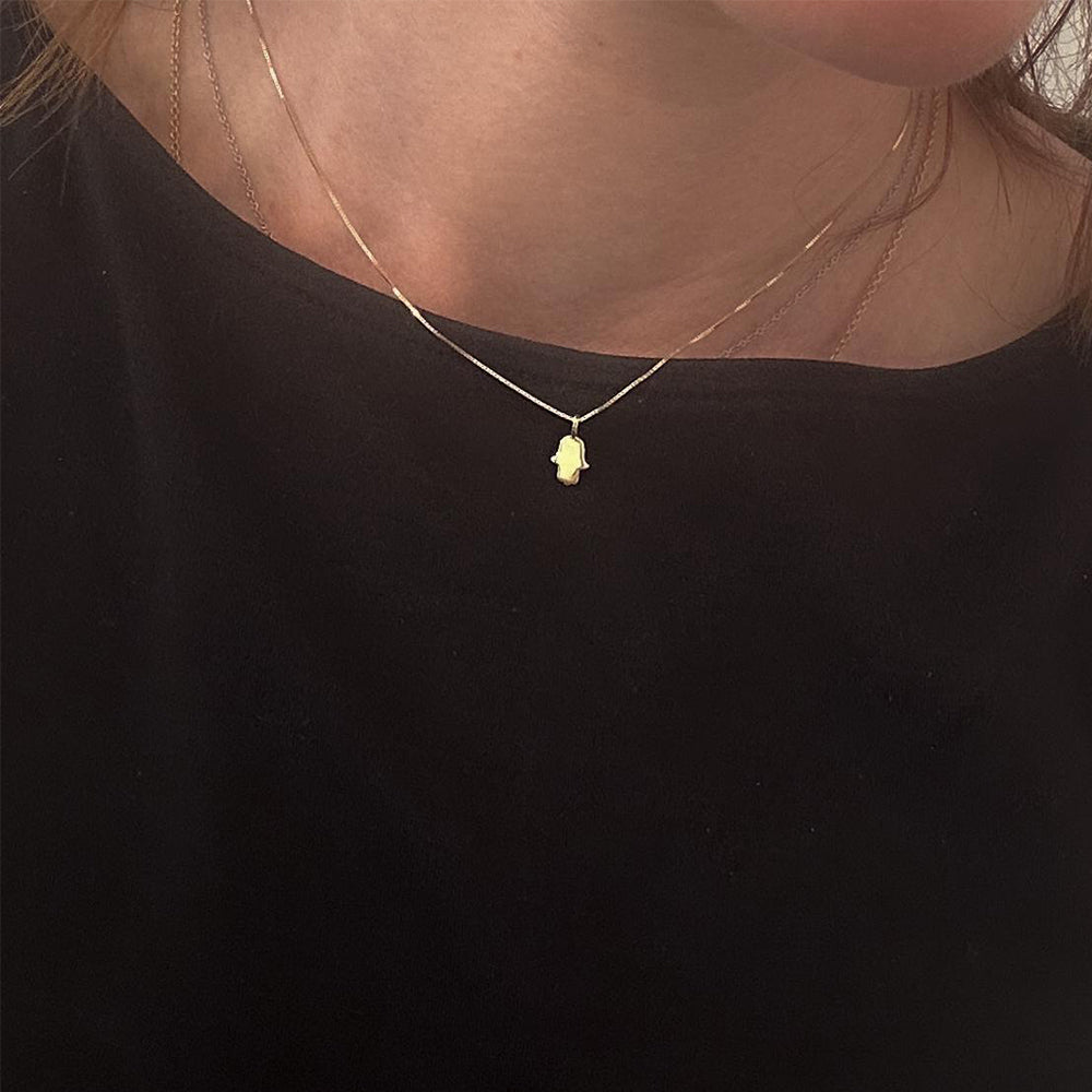 Gold necklace with a full, delicate hamsa pendant