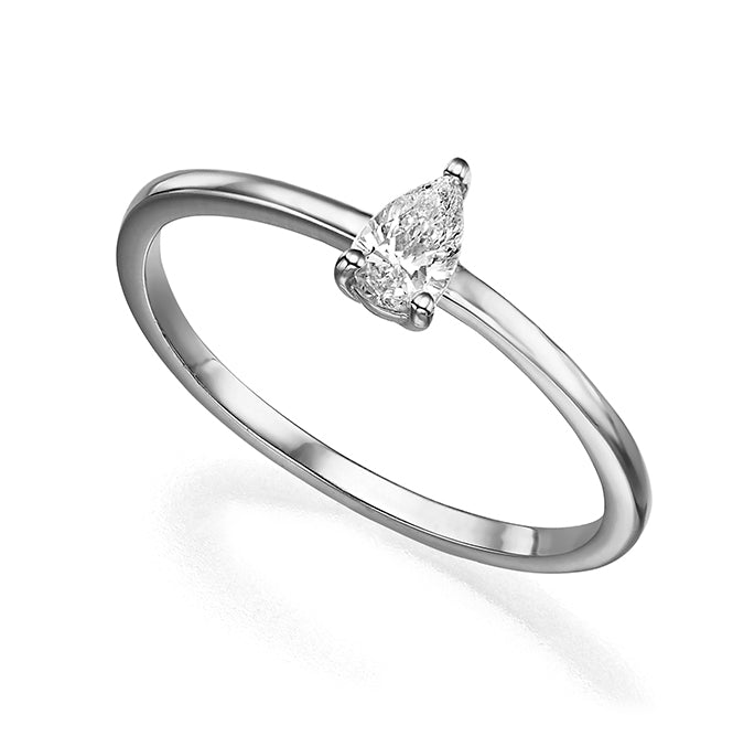 A delicate solitaire ring set with a drop-cut diamond