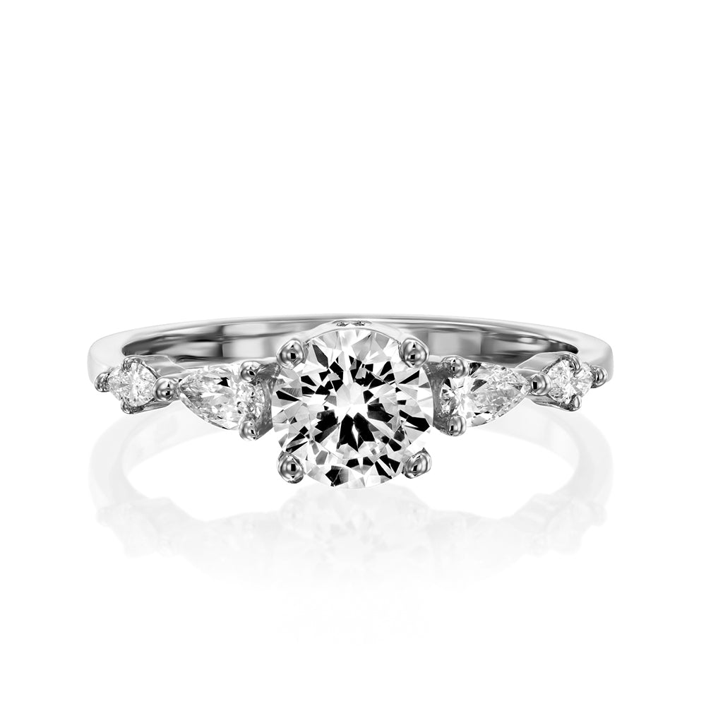 An impressive diamond ring set with a central round diamond combined with drop and marquise cut diamonds