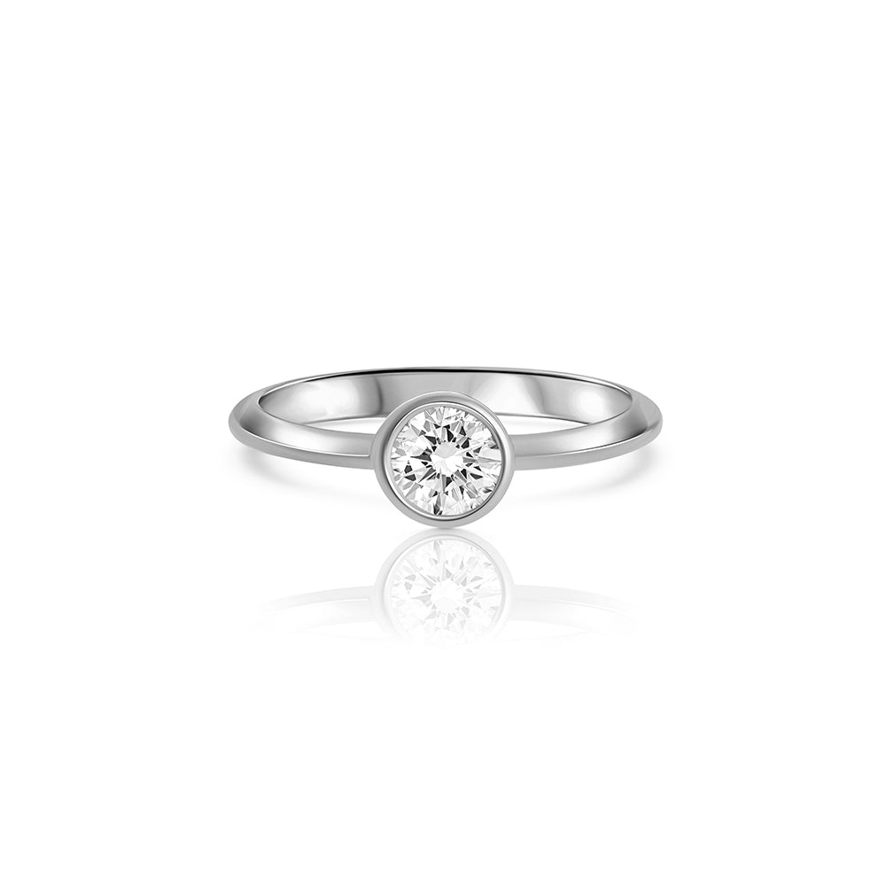 A solitaire ring set with a half carat laboratory diamond in a gold frame.