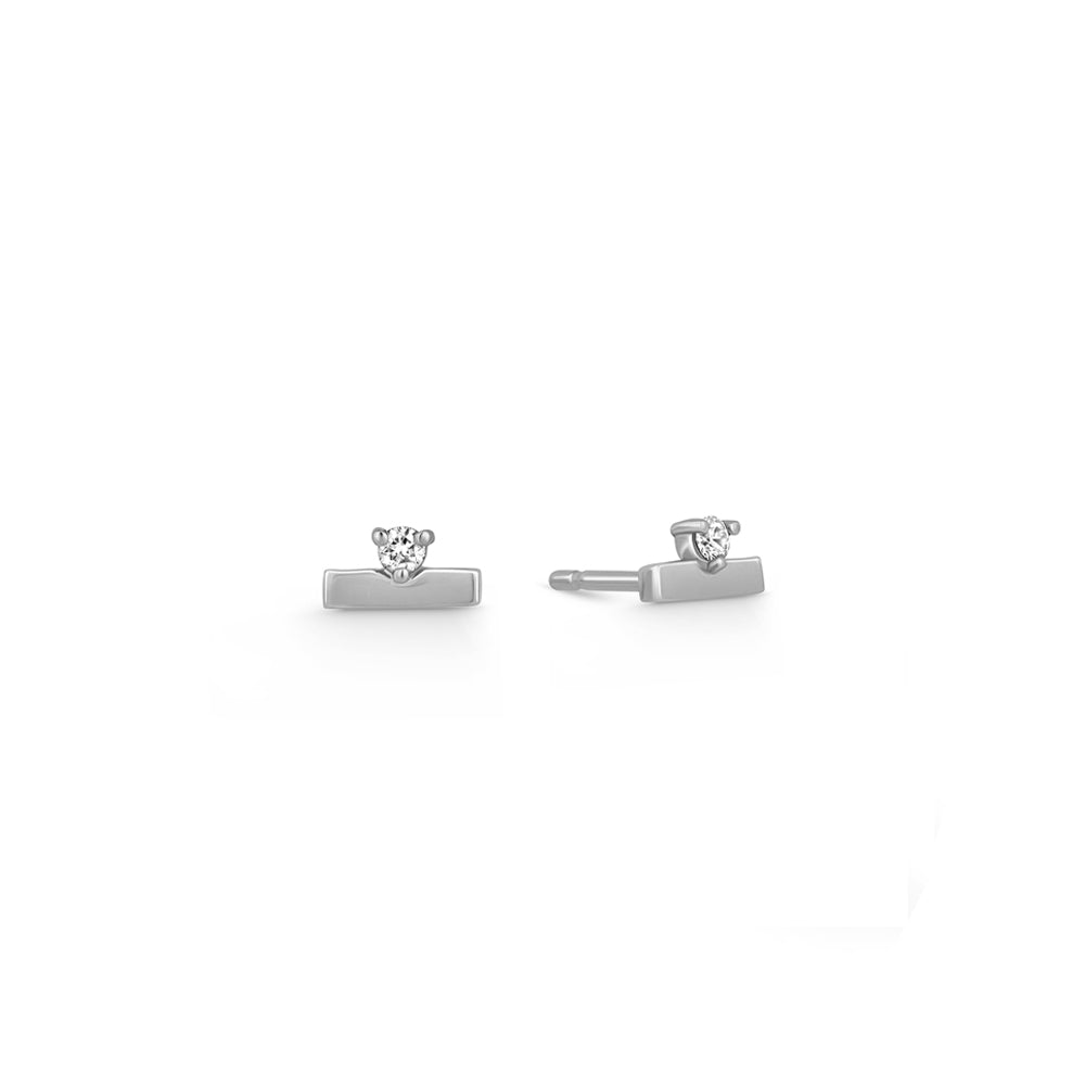 Gold earrings, tight, small, in the form of a stripe, set with a diamond