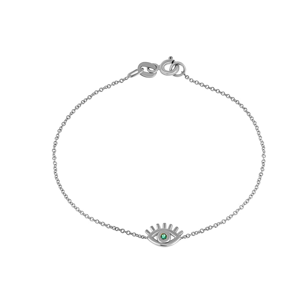 Modern fine gold eyelash bracelet with an emerald in the center