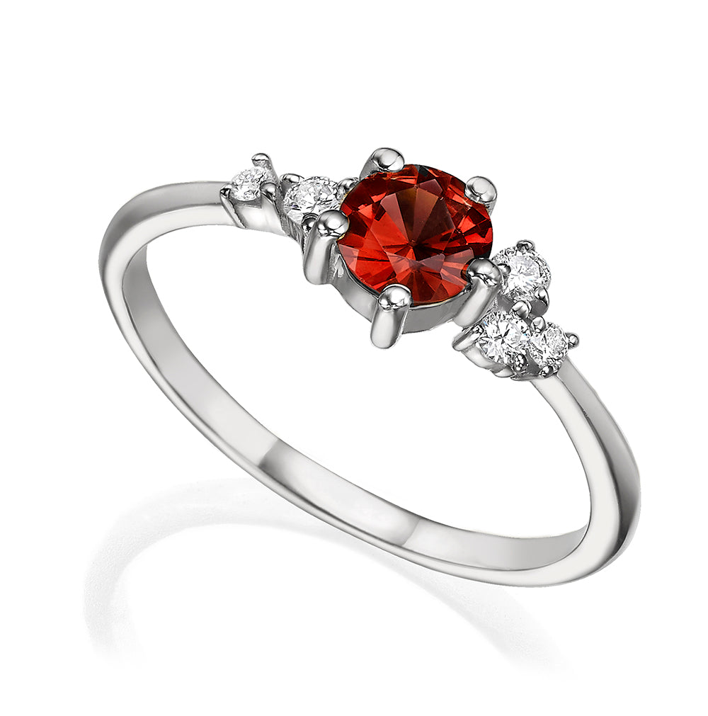 An engagement ring set with rhodolite and small one-centimeter diamonds