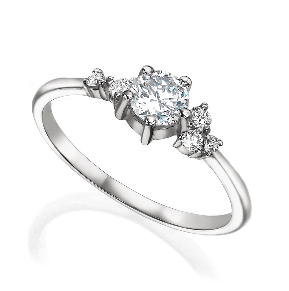 An engagement ring set with a half carat diamond and small asymmetric diamonds