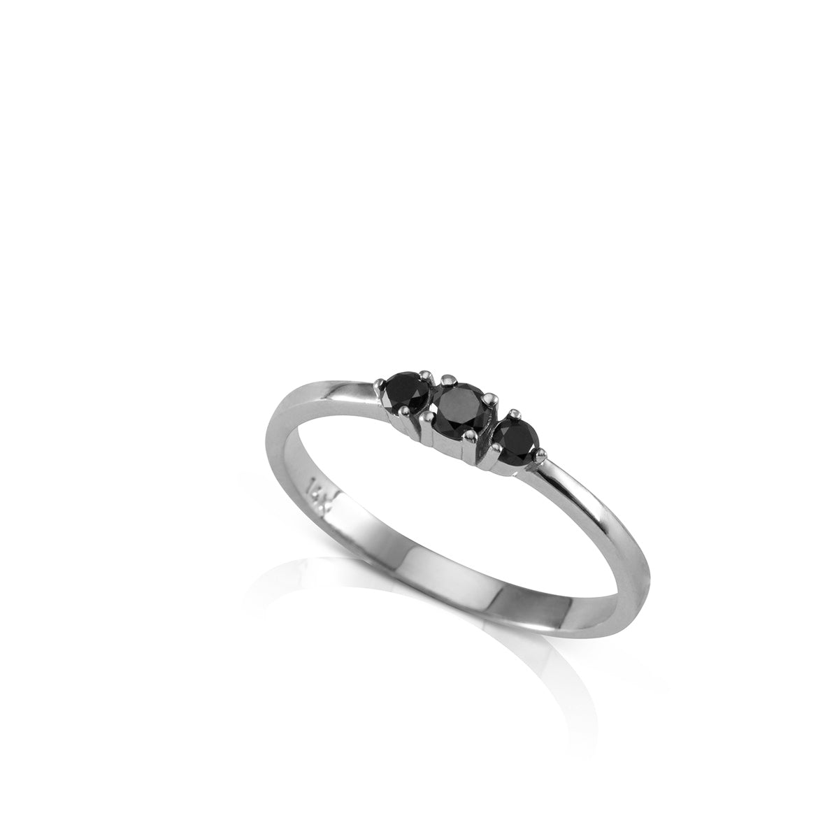 A gold ring set with three black diamonds