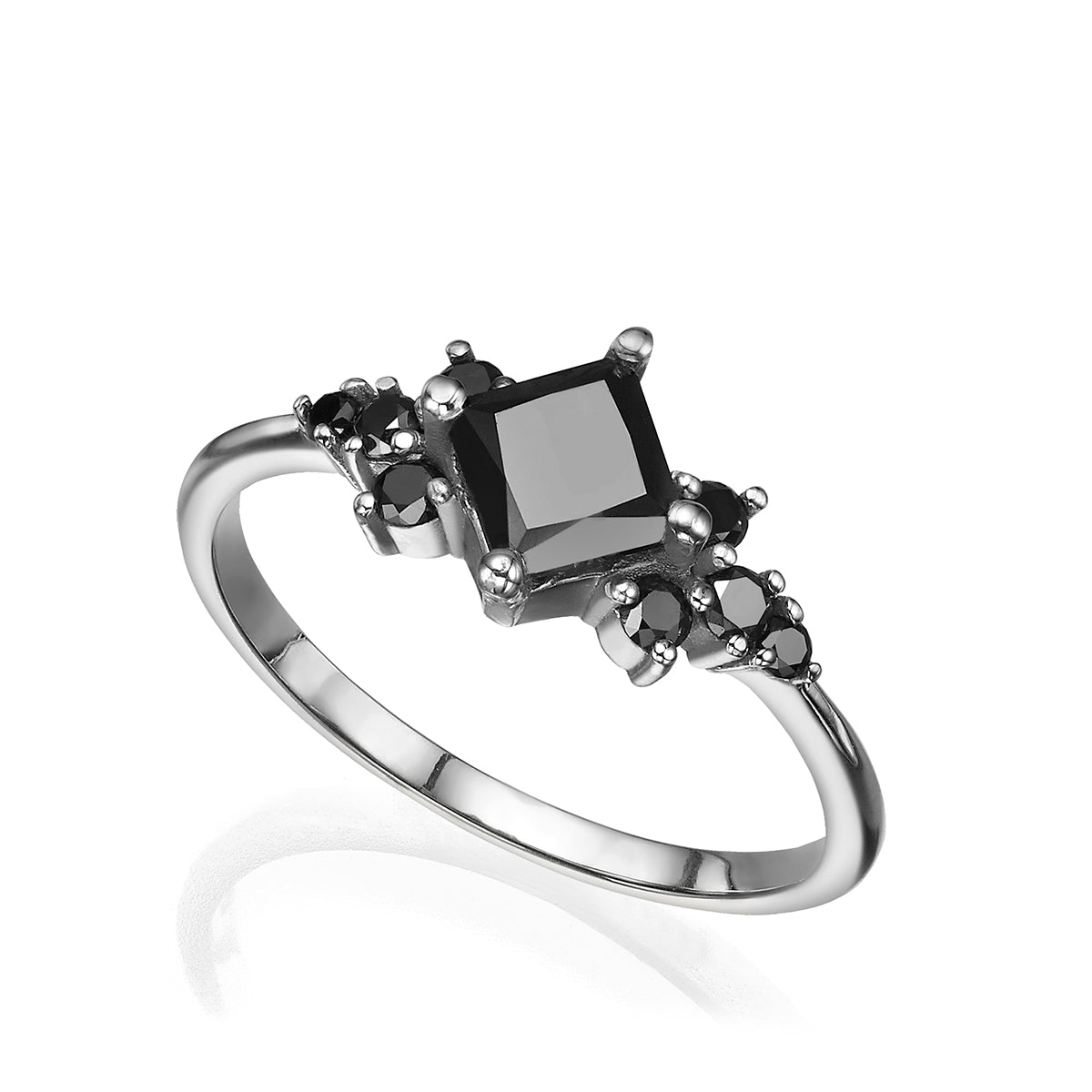 A gold ring set with a princess-cut black diamond and round black diamonds
