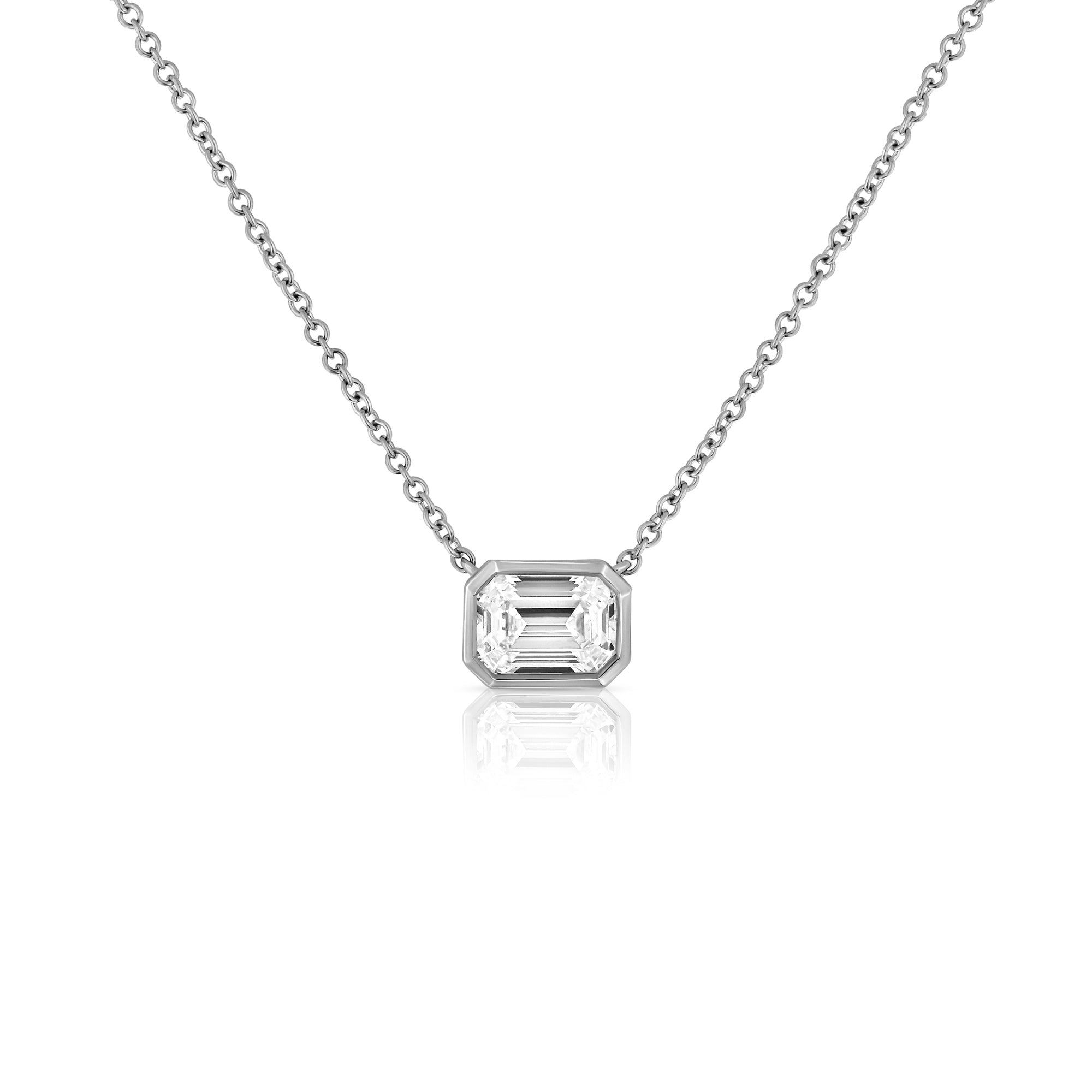 A classic gold necklace set with a 1 carat emerald cut lab diamond
