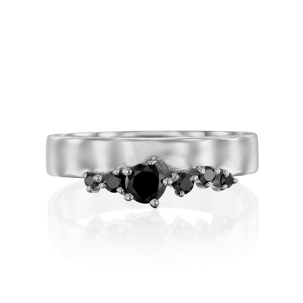 A wide gold ring with a special asymmetrical setting of black diamonds