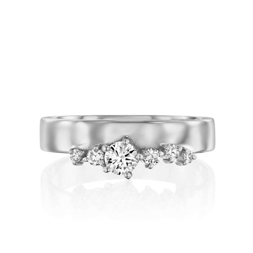 A wide gold ring with a special asymmetric setting of diamonds