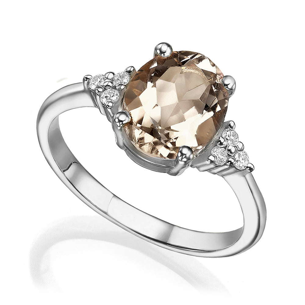 Gold ring set with light smoky quartz in an oval cut and diamonds