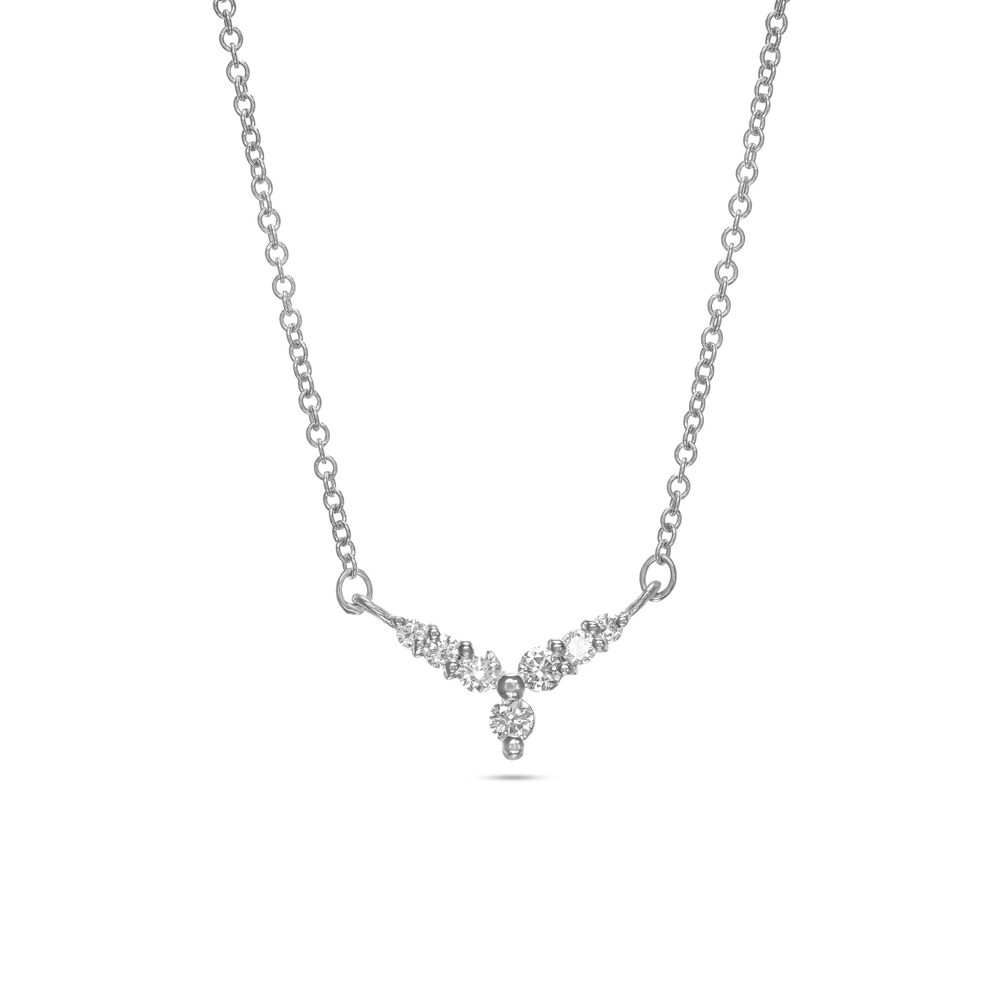 A gold necklace with a V-shaped pendant studded with diamonds reminiscent of a flower